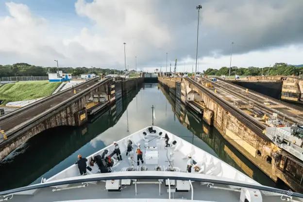Bow of a ship travelling through the narrow locks of the Panama Canal