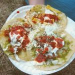 3 chalupas topped with sour cream and salsa