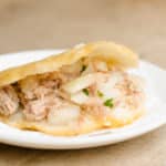 Arepa filled with chicken and onion