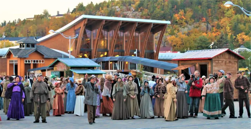 Group of people in period costume performing outside of the cruise pavilion.