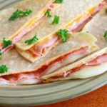 ham and melted cheese between two flour tortillas