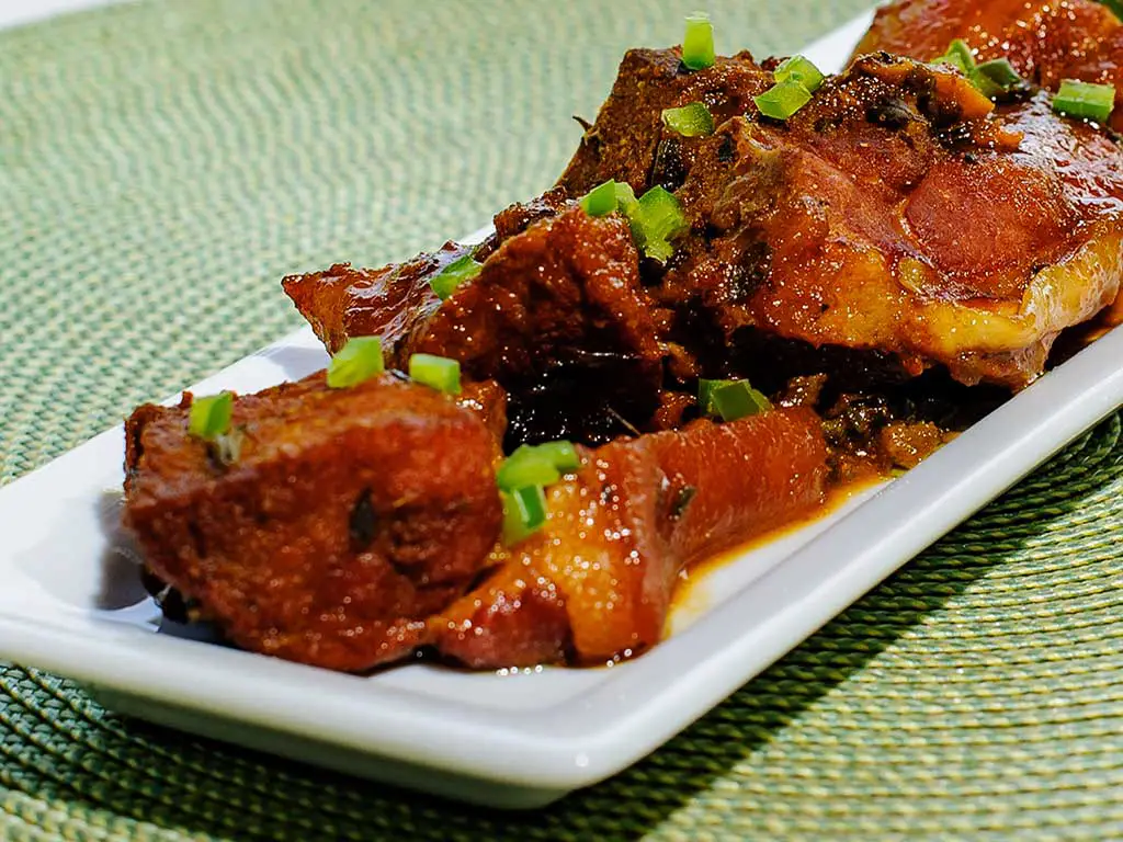 Large chunks of stewed pork on a white plate