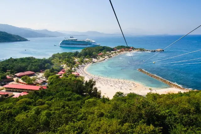 View of the ship, beaches and trees from the top of the zip line