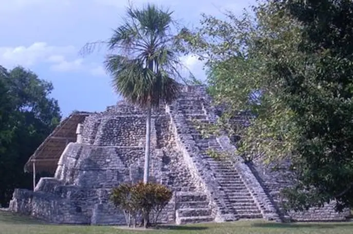 Pyramid-shaped stone ruins with a center staircase running up the middle. 