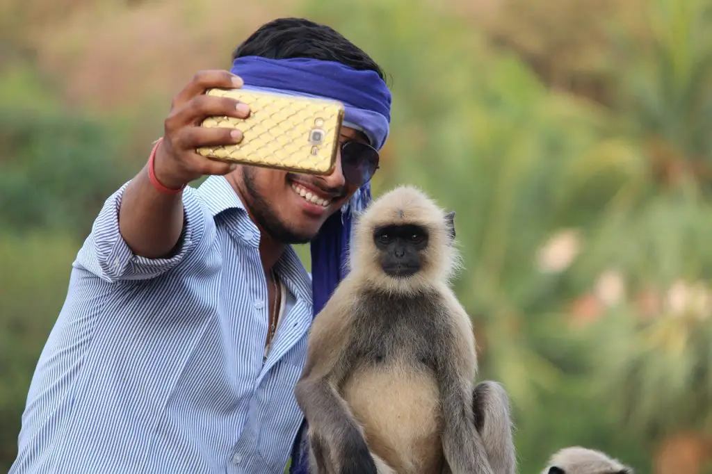 Man taking a selfie with a monkey