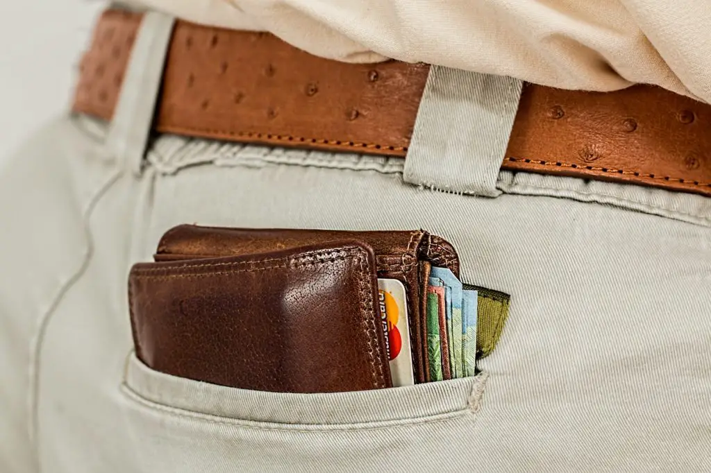 close up of man's back pocket with a full wallet sticking out