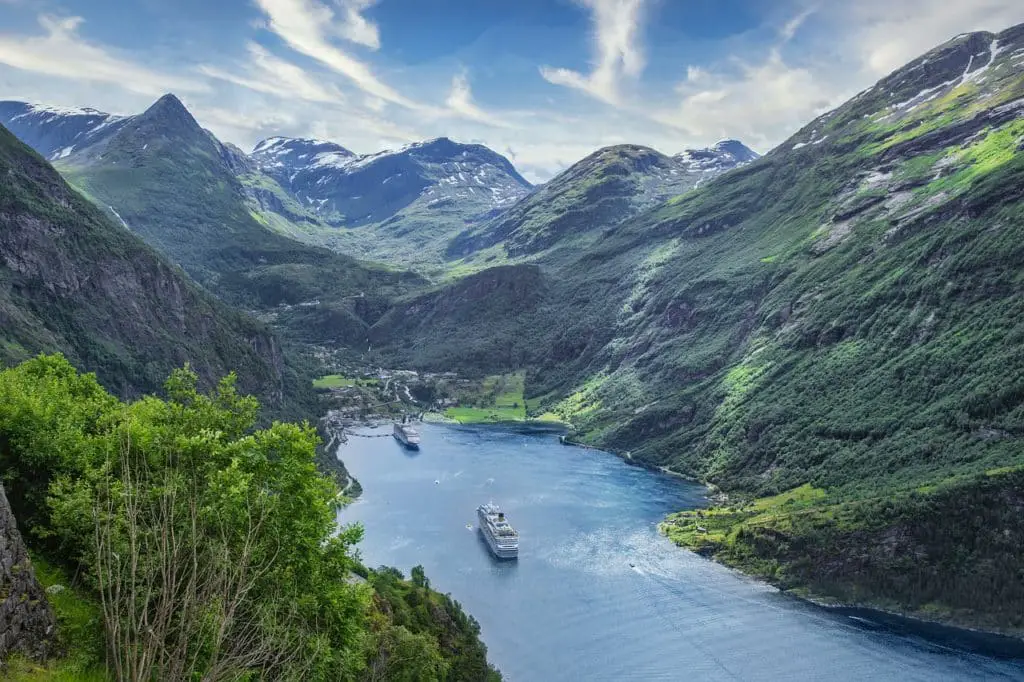 Cruise ships in fjord surrounded by mountains