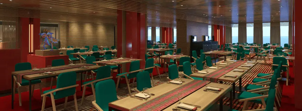 Interior of Chibang - wood paneled walls with large window at one end. green fabric chairs with red and green table runners on light wooden tables