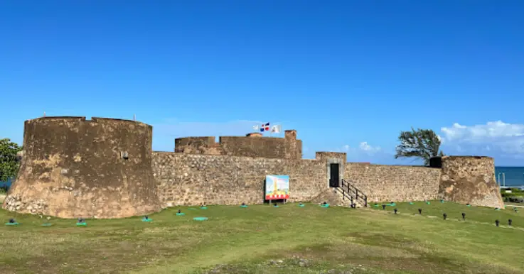 16th Century stone fort with blue skies and green grass.