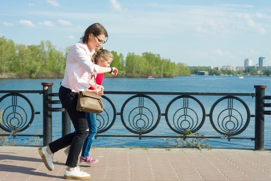 woman and child running late, looking at a watch.
